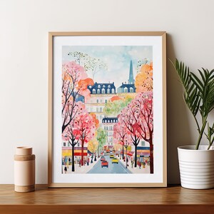 May include: A watercolor painting of a Parisian street scene with colorful buildings and blooming trees. The street is lined with trees in full bloom, with pink and white flowers. Cars are driving down the street, and people are walking on the sidewalk. The painting is framed in a light wood frame.
