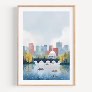 Puede incluir: Una impresión artística enmarcada que representa un horizonte urbano con un puente sobre el agua. La obra de arte presenta un estilo de acuarela con edificios en tonos rojos, azules y verdes. Varios botes de remos están en el agua.