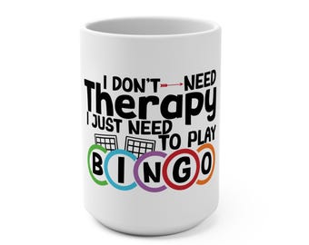 May include: White ceramic mug with black text that reads "I don't need therapy I just need to play BINGO". The letters in BINGO are in colourful circles.