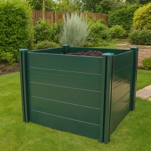 May include: A dark green, square raised garden bed with horizontal wooden planks. The bed is filled with soil and sits on a green lawn. The corners have vertical supports and decorative caps.