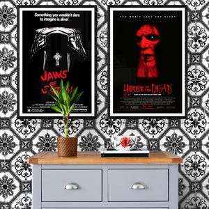 Two movie posters on a white and black tiled wall. The poster on the left is for the movie "Jaws of Satan" and the poster on the right is for the movie "House of the Dead".