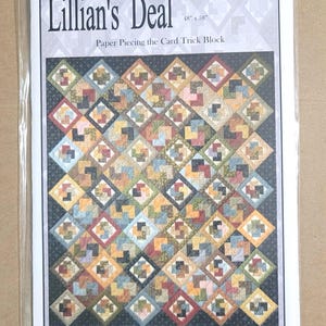 May include: A paper piecing quilt pattern titled "Lillian's Deal" with a colorful geometric design. The pattern measures 48" x 58" and is designed by Judy Rohret. The text "When Quilts Fly" is also visible.