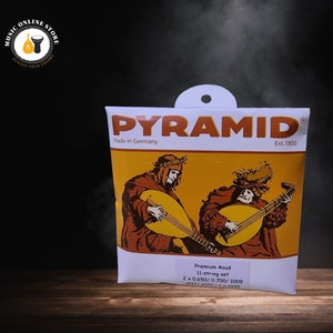May include: A packet of Pyramid Premium Aoud 11-string set guitar strings. The packaging features illustrations of musicians playing lutes, with the brand name and "Made in Germany" printed on the front. The packet is white and orange.