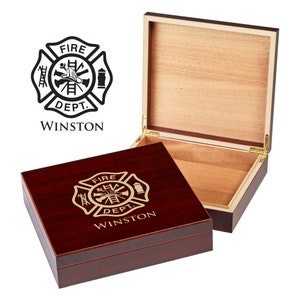May include: A mahogany wood cigar box with a gold engraved fire department logo and the text "FIRE DEPT. WINSTON". The box is open and the inside is lined with cedar wood.