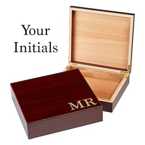 May include: A dark red wooden box with a hinged lid. The box has a gold inscription that reads "MR".