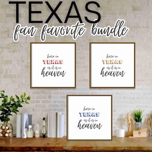 May include: Three framed prints with the text "here in TEXAS as it is in heaven" in red, gold, and blue. The prints are displayed on a wooden surface with books, plants, and decorative items. The words "TEXAS fan favorite bundle" are above the prints.