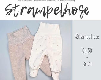 May include: Two pairs of baby leggings, one in a light beige with a textured pattern and one in a white with a small pink dot pattern. The leggings are folded and laid out on a light gray surface. The text "Strampelhose" is written in black on a white background. The text "Gr. 50" and "Gr. 74" are written in black on a white background.