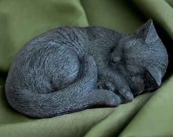 Black cat laying on side statue Concrete sleeping kitten memorial Detailed cat figure