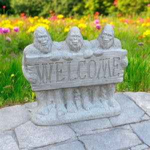 Standing Bigfoots holding welcome figure Concrete front door statue Cement entrance figurine Massive three Bigfoots sculpture
