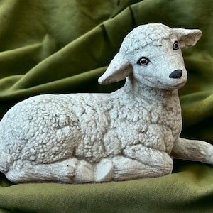 Concrete laying lamb sculpture Detailed resting sheep figurine Realistic lamb statue