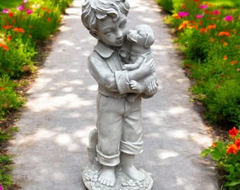 Standing boy holding puppy figure Detailed kid with dog sculpture Backyard concrete decoration Kid holding dog Boy on base memorial statue