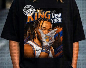 Op de afbeelding: Zwart T-shirt met een afbeelding van een basketballer en de tekst "KING OF NEW YORK". Het ontwerp bevat een kroon, de skyline van New York en de woorden "100% Original Design".
