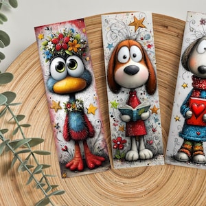 May include: Three whimsical bookmarks. One depicts a blue bird with a floral crown, another a brown dog reading a book, and the last a dog holding a heart-shaped book. Each bookmark has a unique design with vibrant colours.