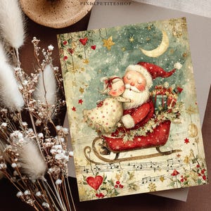 May include: A rectangular greeting card featuring a whimsical illustration of Santa Claus in a red sleigh with a child, surrounded by stars, a crescent moon, and musical notes. The text PIXELPETITESHOP is printed at the top center of the card.