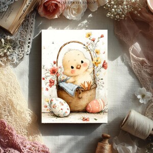 May include: Watercolor illustration of a cute yellow chick in a brown basket, surrounded by flowers and Easter eggs. The artwork has a soft, pastel color palette with a vintage aesthetic. The image is a print.