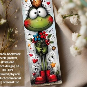 May include: A colourful bookmark with a cartoon frog wearing a crown and red boots, holding flowers. The design includes hearts and stars. The bookmark measures approximately 5 x 15 cm.