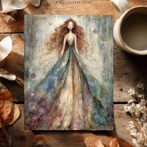 May include: A rectangular art print featuring a central illustration of a figure with long wavy brown hair wearing a flowing gown in shades of blue, green, and gold. The artwork includes delicate gold line details and the text PIXELPETITESHOP.