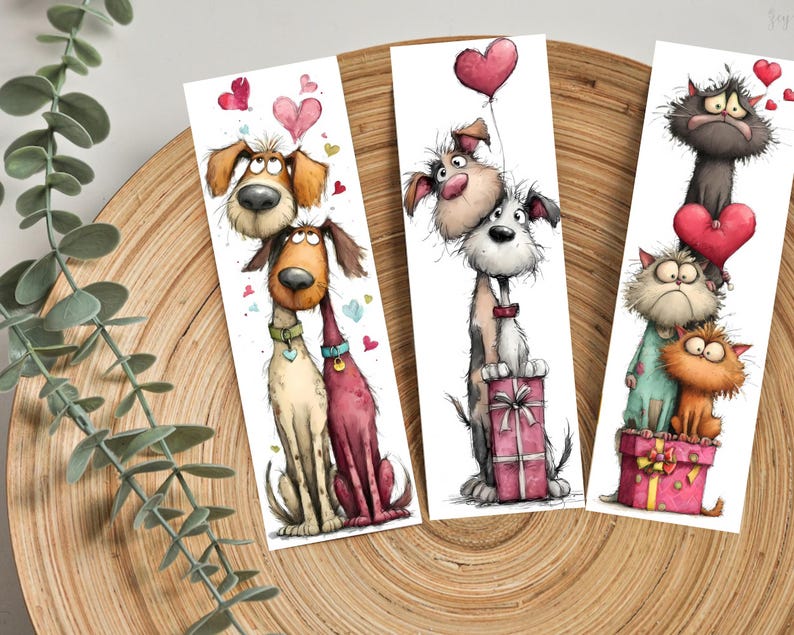 May include: Set of three illustrated bookmarks featuring cartoon dogs and cats. The first bookmark shows two dogs with hearts. The second shows two dogs with a heart balloon and a gift. The third shows three cats with hearts and a gift.