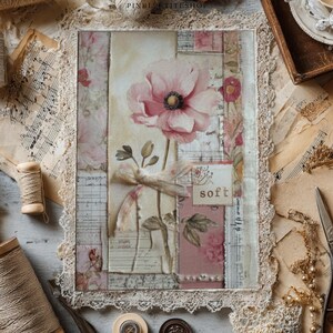 May include: A vintage-style floral art print featuring a large pink poppy with a dark center. The artwork is framed with lace and includes the word "soft". The background incorporates aged paper and musical notes, with spools of twine and vintage accessories.