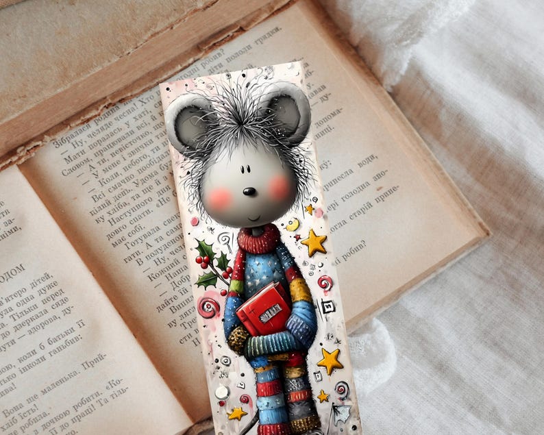 May include: A charming bookmark depicting a cartoon mouse in a colourful sweater, holding a red book. The design includes stars, holly, and candy cane motifs. The bookmark is set against the backdrop of an open, vintage book.