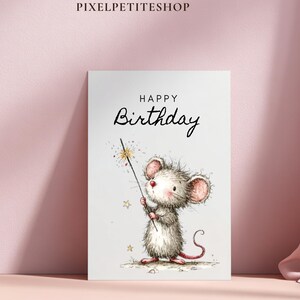 May include: A birthday greeting card featuring a watercolor illustration of a cute mouse holding a sparkling wand. The card has the words "HAPPY Birthday" in elegant script. The mouse is gray and white with pink ears and a red nose.
