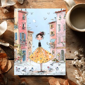 May include: A whimsical illustration print featuring a central figure with a dark polka-dot top and a voluminous yellow floral skirt standing on a cobblestone street. The scene is framed by tall pink and beige buildings with balconies and birds.