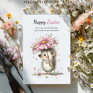 May include: A greeting card with the text "Happy Easter" and a watercolor illustration of a hedgehog holding a flower umbrella. The card is surrounded by flowers.