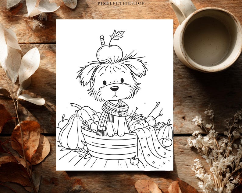 May include: A black and white line art illustration featuring a small, fluffy dog wearing a striped scarf, sitting inside a basket filled with pumpkins and apples. An apple rests on the dog's head. The text PIXELPETITESHOP appears at the top center.