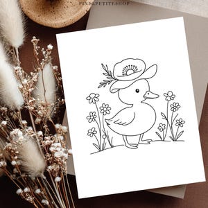 May include: A black and white line art drawing on a rectangular card featuring a small duckling wearing a large flower as a hat, standing among several simple daisies. The text PIXELPETITESHOP is printed in small black letters at the top centre.