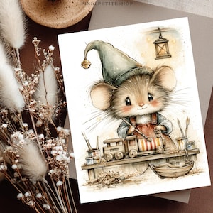 May include: A watercolor-style illustration on a rectangular card featuring a small mouse wearing a green pointed hat with a bell, painting a wooden toy train. The scene includes paintbrushes, jars of paint, and a small wooden boat on a workbench.