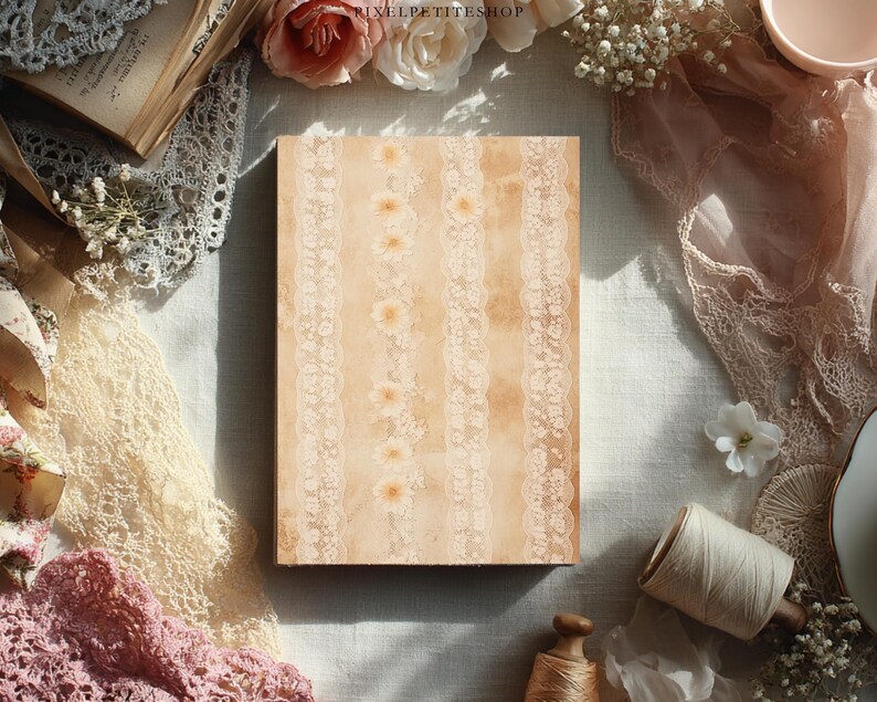 May include: A rectangular journal with a beige cover featuring vertical lace and floral patterns. The journal is surrounded by vintage-style lace, flowers, and a spool of thread, creating a romantic, antique aesthetic.