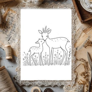 May include: A black and white line art illustration on a white background featuring an adult deer and a fawn standing together in a field of simple flowers. The adult deer has a small floral crown on its head and is nuzzling the smaller fawn.