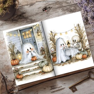 May include: An open book featuring two watercolor illustrations. The left page shows a white ghost sitting on porch steps with orange pumpkins and string lights. The right page shows a ghost and a skeleton having tea with pumpkins and lights.