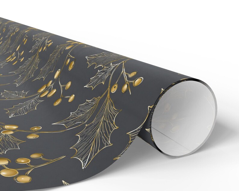May include: A roll of wrapping paper with a repeating pattern of gold holly leaves and berries on a dark gray background. The paper is rolled up, revealing the white interior.