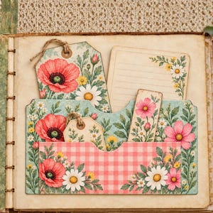 May include: A scrapbook page featuring a pocket with a pink and white gingham pattern, decorated with illustrations of red poppies, white daisies, and green foliage. The pocket holds a floral tag, a lined note card, and a rectangular floral bookmark.