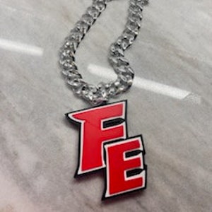 May include: A silver chain necklace with a large red plastic pendant that says "FE".