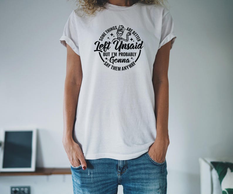 May include: White t-shirt with a black graphic print of a skeleton holding a paintbrush and the text "Some things are better left unsaid but I'm probably gonna say them anyway".