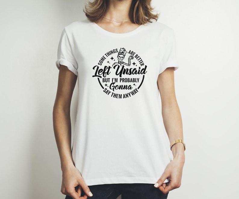 May include: White t-shirt with a black graphic print that says "Some things are better left unsaid but I'm probably gonna say them anyway". The graphic also includes a skeleton holding a mug.