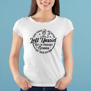 May include: White t-shirt with a black graphic design featuring a skeleton with the text "Some things are better left unsaid but I'm probably gonna say them anyway".