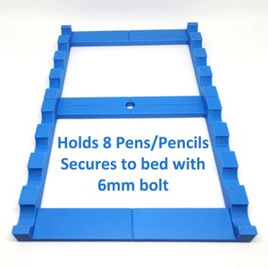 May include: A blue plastic pen holder that holds 8 pens or pencils. It secures to a surface with a 6mm bolt. Holds 8 Pens/Pencils Secures to bed with 6mm bolt