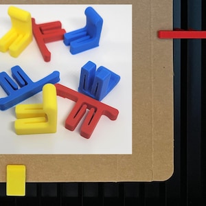 May include: Assortment of colorful plastic corner protectors in blue, red, and yellow. These corner protectors are designed to protect furniture and other items from damage.