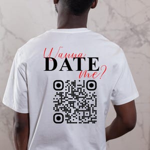 May include: White t-shirt with the text "Wanna DATE me?" in red and black lettering. A black and white QR code is below the text.