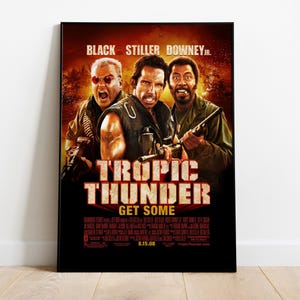 May include: Movie poster for the film "Tropic Thunder" featuring actors Jack Black, Ben Stiller, and Robert Downey Jr. in jungle camouflage with guns. The poster has a red and orange background with the title "Tropic Thunder" in large white letters and the tagline "Get Some" in smaller white letters.