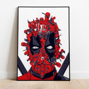 Puede incluir: Una impresi&oacute;n art&iacute;stica enmarcada que presenta una ilustraci&oacute;n estilizada de la cara de Deadpool. La obra de arte est&aacute; compuesta por numerosas figuras rojas de Deadpool, con formas de ojos negros y las palabras "DEAD" y "POOL" en blanco. El fondo es blanco.