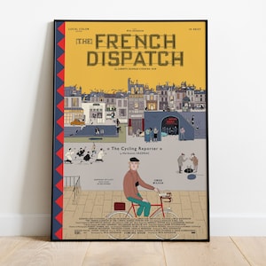 May include: A movie poster for the film "The French Dispatch" directed by Wes Anderson. The poster features a yellow background with a cityscape illustration and a man riding a bicycle. The text "The French Dispatch" is in large, bold letters. The poster also includes the text "Liberty, Kansas Evening Sun" and "The Cycling Reporter" by Herbsaint Sazerac.