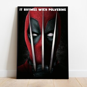 Puede incluir: Impresi&oacute;n en lienzo enmarcada que presenta un primer plano de un personaje con un traje rojo y negro con tres garras plateadas. El texto "IT RHYMES WITH WOLVERINE" est&aacute; impreso en la parte superior. El fondo es oscuro.