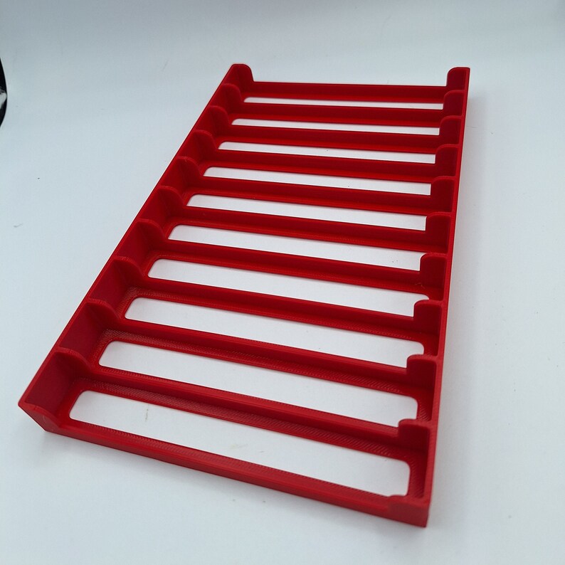 May include: Red plastic organizer with 10 slots for storing small items.
