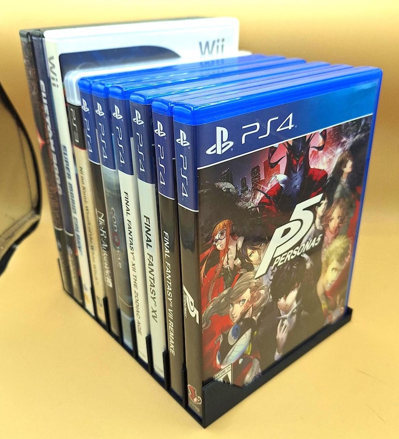 Diagonal right view of a black video game or DVD storage tray in 10 slots featuring wall extensions at the front of each slot to better secure the cases and a slightly elevated back wall. Ten video games are displayed in the tray.