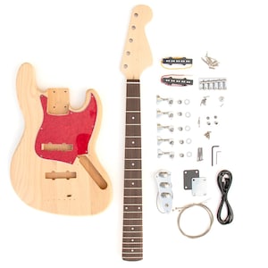 May include: An unfinished electric bass guitar kit featuring a light-colored wooden body with a red pearloid pickguard, a separate maple neck with a dark fretboard, two black pickups, chrome tuning pegs, a bridge, control plate, and cables.