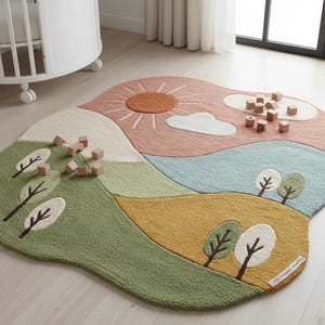 May include: A whimsical, landscape-themed rug with a sun, clouds, and trees. The rug features a color palette of green, yellow, blue, and pink. Wooden blocks are scattered across the rug, suggesting a play area. The rug's irregular shape adds to its playful design.